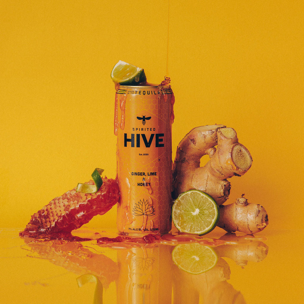 Hive drink can with ginger and lime on a yellow background